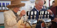 SAINT JOHNS, CANADA - MAY 17: Prince Charles, Prince of Wales and Camilla, Duchess of Cornwall pull pints as they visit Quidi Vidi Brewery during their tour of Quidi Vidi Village on day one of the Platinum Jubilee Royal Tour of Canada on May 17, 2022 in St John's, Newfoundland and Labrador, Canada. The Prince of Wales and Duchess of Cornwall are visiting for three days from 17th to 19th May 2022. The tour forms part of Queen Elizabeth II's Platinum Jubilee celebrations. (Photo by Jacob King - Pool/Getty Images)