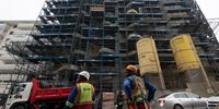 Workers in front of an apartment complex construction site in Sea Point, 09 September 2025. (Photo: David Harrison)
