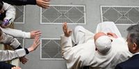 Pope Francis, sitting on a wheelchair, greets the faithful during his weekly general audience in the Paul VI Audience Hall, Vatican City, 10 January 2024.  EPA-EFE/MAURIZIO BRAMBATTI