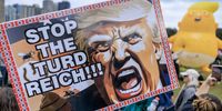 A placard depicting  Trump and reading 'Stop the Turd Reich' is displayed during the 'No Kings' protest in Chicago. (Photo: Cristobal Herrera-Ulashkevich) 