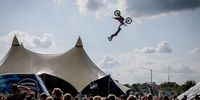 A stunt rider performs on the first day of Black Cross (Zwarte Cross) in Lichtenvoorde, Netherlands, 17 July 2025. The four-day music, theater and motocross event takes place in the Achterhoek region for the 27th time and runs from 17 to 20 July 2025.  EPA/EMIEL MUIJDERMAN