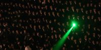 A participant uses a laser while other Ultra-Orthodox Jewish men gather around a bonfire in the neighborhood of Mea Shearim during the holy day of Lag Ba'Omer in Jerusalem, 08 May 2023. The day marks the anniversary of the death of Rabbi Shimon bar Yochai, a sage from some 1,800 years ago, and the day on which he revealed the secrets of the 'kabbalah,' or Jewish mysticism.  EPA-EFE/ABIR SULTAN