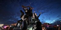 OAKLAND, CALIFORNIA - MAY 29: Demonstrators stand on top of a semi truck on Interstate 880 during a protest sparked by the death of George Floyd while in police custody on May 29, 2020 in Oakland, California. Earlier today, former Minneapolis police officer Derek Chauvin was taken into custody for Floyd's death. Chauvin has been accused of kneeling on Floyd's neck as he pleaded with him about not being able to breathe. Floyd was pronounced dead a short while later. Chauvin and 3 other officers, who were involved in the arrest, were fired from the police department after a video of the arrest was circulated. (Photo by Justin Sullivan/Getty Images)