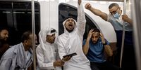 epa10352436 People in the metro celebrate as they watch on a mobile phone Morocco winning the FIFA World Cup 2022 Round of 16 match against Spain, Doha, Qatar, 06 December 2022.  EPA-EFE/MARTIN DIVISEK