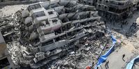 An aerial view shows people inspecting the destroyed Al-Aklouk Tower following Israeli air strikes, in Gaza City, 08 October 2023. The air strikes, in retaliation for the 07 October Hamas rocket attacks on Israel, have killed over 300 people in the Gaza Strip, with almost 2,000 wounded, according to Palestinian official sources.  EPA-EFE/MOHAMMED SABER