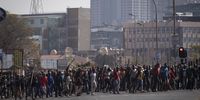 Supporters of former president Jacob Zuma march through the streets during clashes in downtown Johannesburg on 11 July 2021. (Photo: EPA-EFE / KIMLUDBROOK)