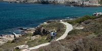 HERMANUS, SOUTH AFRICA  - MARCH 15: A general view of people walking along the cliff path in front of the Hermanus Esplanade on March 15, 2021 in Hermanus, South Africa. Hermanus is a seaside town southeast of Cape Town which is known as a whale-watching destination. (Photo by Gallo Images/Misha Jordaan)