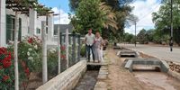 Jan-Hendrik Swiegers, his wife Michelle and the gurgling water furrow in front of their guesthouse. Image: Chris Marais