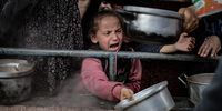 Palestinian children wait in line to receive food prepared by volunteers for displaced Palestinian families in Rafah, Gaza on 10 February 2024. (Photo: Belal Khaled / Anadolu / Anadolu via AFP)