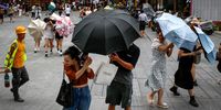 People use umbrellas against strong winds at a shopping district in Guangzhou, Guangdong province, China, 01 September 2023. China’s National Meteorological Center has issued a red alert, the highest alert as Typhoon Saola is forecasted to bring heavy rains along the coastal regions. Multiple regions such as Shenzen and Hong Kong have suspended school, business and transportation as safety precautions for Typhoon Saola who exited the Philippines causing the evacuation of at least 48,000 people.  EPA-EFE/MARK R. CRISTINO