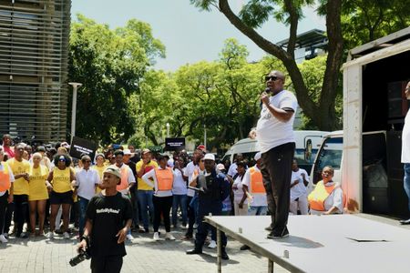 Lottery supporters march against journalists who exposed corruption