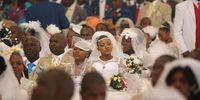 ZUURBEKOM, SOUTH AFRICA  SEPTEMBER 1: Brides and grooms during a mass wedding at the International Pentecostal Holiness Church on September 1, 2013 in Zuurbekom, South Africa. On Sunday 396 couples married at the church. IPHC is among the few churches which allow polygamous marriages with its mass weddings celebrated several times a year. (Photo by Gallo Images / Sowetan / Veli Nhlapo)