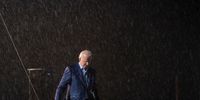 TAMPA, FL - OCTOBER 29: Democratic presidential nominee Joe Biden leaves the stage during a downpour after concluding his remarks at a drive-in campaign rally at the Florida State Fairgrounds on October 29, 2020 in Tampa, Florida. Biden is campaigning in Florida on Thursday, with drive-in rallies in Tampa and Broward County. (Photo by Drew Angerer/Getty Images)