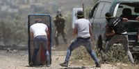 Palestinian protesters take cover as they throw stones at Israeli troops during clashes after a demonstration against Israel's settlements on the lands of Kafr Qadoum village near the West Bank city of Nablus, 10 June 2022.  EPA-EFE/ALAA BADARNEH