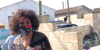 Minister of Human Settlements, Water and Sanitation Lindiwe Sisulu responding to housing activist Nkosikhona Swartbooi about unfulfilled promises during a walkabout visiting fire victims in Khayelitsha, Cape Town. (Screenshot: Twitter / Axolile Notywala @Xila_Notywala)<br>