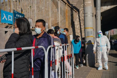 Chinese capital steps up Covid-19 measures as cases quadruple