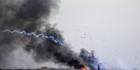 A Palestinian protester throws a tear gas canister back during clashes with Israeli troops on the eastern border of the Gaza Strip, 26 September 2023. According to the Palestinian Ministry of Health, at least 11 Palestinian protesters were wounded during the clashes.  EPA-EFE/MOHAMMED SABER