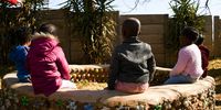 Children at Thoriso Nursery School sit on an eco-brick bench. (Photo: Julia Evans)