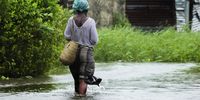 A woman walks on a flooded street near Quelimane, as Cyclone Freddy hits in Quelimane, Mozambique, 11 March 2023. (Photo: EPA-EFE / Andre Catueira) 