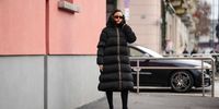 A guest wears sunglasses, a black long puffer winter jacket, outside K-WAY, during the Milan Fashion Week - Menswear Fall/Winter 2024-2025 on January 14, 2024 in Milan, Italy. (Photo by Edward Berthelot/Getty Images)