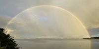 Rainbow over lagoon. Photographer: Philippa Sauvenier