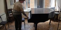 epa09922883 A woman touches a piano as she inspects the damage inside a classroom after shelling at Kharkiv National Kotlyarevsky University of Arts in Kharkiv, Ukraine, 02 May 2022. This year the Kharkiv National Kotlyarevsky University of Arts marks 105 years since its founding. Russian troops entered Ukraine on 24 February resulting in fighting and destruction in the country and triggering a series of severe economic sanctions on Russia by Western countries.  EPA-EFE/SERGEY KOZLOV