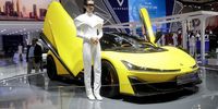A model stands beside a Chinese electric supercar Hyper SSR during the Gaikindo Indonesia International Auto Show (GIIAS) 2024, in Tangerang, Banten province, Indonesia, 19 July 2024. The 31st edition of the Gaikindo Indonesia International Auto Show runs from 18 to 28 July 2024, with the participation of at least 55 global automotive and motorcycle brands. As of 2024, GIIAS is set to become the second largest auto show in the world after China's Beijing Motor Show.  EPA-EFE/BAGUS INDAHONO