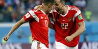 Artem Dzyuba of Russia (R) and Roman Zobnin of Russia react after an own goal by Ahmed Fathi of Egypt the FIFA World Cup 2018 group A preliminary round soccer match between Russia and Egypt in St.Petersburg, Russia, 19 June 2018. EPA-EFE/ETIENNE LAURENT   <br>(RESTRICTIONS APPLY: Editorial Use Only, not used in association with any commercial entity - Images must not be used in any form of alert service or push service of any kind including via mobile alert services, downloads to mobile devices or MMS messaging - Images must appear as still images and must not emulate match action video footage - No alteration is made to, and no text or image is superimposed over, any published image which: (a) intentionally obscures or removes a sponsor identification image; or (b) adds or overlays the commercial identification of any third party which is not officially associated with the FIFA World Cup)  EPA-EFE/ETIENNE LAURENT   EDITORIAL USE ONLY  EDITORIAL USE ONLY