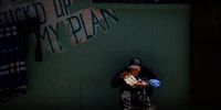 A homeless man sits outside Florence House eating a meal that was donated to him. (Photo: Shiraaz Mohamed)