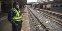 A security guard patrols the desolate Jeppe train station. (Photo: Shiraaz Mohamed)