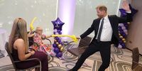 LONDON, ENGLAND - SEPTEMBER 8: Prince Harry, Duke of Sussex play fights using swords made from modelling balloons with nine-year-old Gwen Foster, recipient of Inspirational Child 7-11 award, at the annual WellChild Awards 2025, which celebrates the achievements and resilience of seriously ill youngsters and their families, at the Royal Lancaster Hotel on September 8, 2025 in London, England. (Photo by Aaron Chown - Pool/Getty Images)