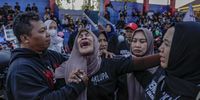Rini Handayani (C) cries as she calls her son's name during a rally to mark the first anniversary of the deadly stampede at Kanjuruhan Stadium in Malang, East Java, 01 October 2023. Fans and family of the victims prepared to gather at the stadium to mark the first anniversary of Kanjuruhan stadium stampede that killed at least 135 people following the soccer match between Arema FC and Persebaya Surabaya in East Java on 01 October 2022, after police fired tear gas to stop soccer fans from entering the pitch causing panic.  EPA-EFE/MAST IRHAM