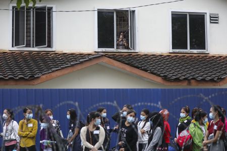 Malaysia to charge Top Glove over poor worker accommodation, government says