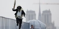 PARIS, FRANCE - JULY 26: A torchbearer runs atop the Musee d'Orsay during the Opening Ceremony of the Olympic Games Paris 2024 on July 26, 2024 in Paris, France. (Photo by Peter Cziborra - Pool/Getty Images)