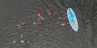  An aerial view of youngsters stand on a paddle boarding in Bewl Water reservoir on July 17, 2025 in Lamberhurst, England. In mid-May this year, Bewl Water reservoir was 86.4% full. However, following three Met Office-defined heatwaves throughout June and July, and Kent only receiving 35% of its expected rainfall, it now stands at 70%. Bewl Water supplies both Kent and Sussex with water, and hosepipe bans come into effect in these two counties as from tomorrow, July 18.   (Photo by Carl Court/Getty Images)