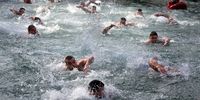 Serbs Orthodox believers swim in the cold water of the river of the river Drina during the celebrations of the Epiphany Orthodox holiday, in Visegrad, Bosnia and Herzegovina, 19 January 2024. People believe that swimming into blessed waters during the holiday of Epiphany strengthens their spirit and body.  EPA-EFE/FEHIM DEMIR