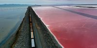 CORINNE, UTAH - AUGUST 02: In an aerial view, a railroad causeway divides the Great Salt Lake on August 02, 2021 near Corinne, Utah. As severe drought continues to take hold in the western United States, water levels at the Great Salt Lake, the largest saltwater lake in the Western Hemisphere, have dropped to the lowest levels ever recorded. The lake fell below 4194.4 feet in the past week after years of decline from its highest level recorded in 1986 with 4211.65 feet. Further decline of the lake's water levels could result in an increase in water salinity and could generate dust from the exposed lakebed that could impact air quality in the area. The lake does not supply water or generate electricity for nearby communities but it does provide a natural habitat for migrating birds and other wildlife. According to the U.S. Drought Monitor, 99 percent of Utah is experiencing extreme drought conditions. (Photo by Justin Sullivan/Getty Images)