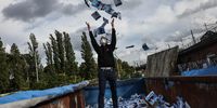 An activist in a rubbish container full of election flyers for the Alternative fuer Deutschland in Berlin on 30 September 2021. The emergence of the right-wing party has been offset by the emergence of a voting bloc for a progressive ecological and socioeconomic project. (Photo: EPA-EFE/Filip Singer)