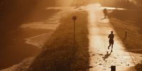 Runners jog in the early sunshine along the flooded embankment of the river Danube on September 17, 2024 in Bratislava, Slovakia. (Photo by Robert Nemeti/Getty Images)