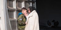 KYIV, UKRAINE - MARCH 23: Liudmyla, the mother of a Ukrainian serviceman Vladyslav Buvalkin, 42, who was killed in action, and his son, Daniil, 11, comfort each other after the funeral on March 23, 2022 in Kyiv, Ukraine. Ukrainian forces have managed to fend off Russian advances near the capital, although shellfire and aerial bombardment persist. (Photo by Anastasia Vlasova/Getty Images)