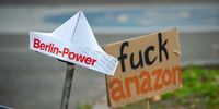 Banners and hats placed in the ground by activists of the civil society group 'Berlin vs Amazon' demonstrating against the opening of the Amazon Tower on October 26, 2024 in Berlin, Germany.  (Photo by Craig Stennett/Getty Images)