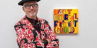 Bob and Roberta Smith poses with 'Art does real and permanent good', 2022, during the opening of 'Art for AT The Bus' exhibition at Sotheby's on April 29, 2024 in London, England. AT the Bus, opens April 29 at Sotheby’s and will remain on view until May 7 in its New Bond Street galleries. The works will be sold via online auction, powered by Artsy, and open for bidding until 10 May 2024, with proceeds going to AT The Bus. (Photo by Tristan Fewings/Getty Images for Sotheby's)