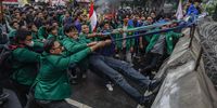 Students pull down the barriers during an anti-government protest near the presidential palace in Jakarta, Indonesia, 17 February 2025. Hundreds of students staged a protest against the government's recent policies on budget efficiencies.  EPA-EFE/MAST IRHAM