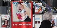 People walk past a photo in Tel Aviv, Israel, of Hamas hostage, Israeli toddler Kfir Bibas on 18 January 2024. (Photo: EPA-EFE / Abir Sultan)