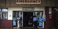 Nurses stand at the entrance of the emergency unit at Steve Biko Academic Hospital where they conduct Covid screening on everyone who enters. (Photo: Shiraaz Mohamed)
