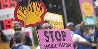 Activists gather along the M3 at the Shell garage in Newlands, Cape Town, on 4 December 2021 to protest against a seismic survey along the Wild Coast commissioned by Shell. (Photo: Gallo Images / Brenton Geach)