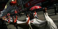CHANGCHUN, CHINA - APRIL 29: (CHINA OUT) Models show a 203-foot-long wedding dress April 29, 2007 in Changchun of Jilin Province, China. Many people now choose to customize wedding dresses to show their unique taste, although customized wedding dresses are much more expensive than traditional ones, according to reports. (Photo by China Photos/Getty Images)