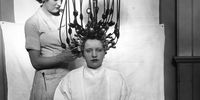 A woman having a perm using a new perming machine made by Messrs Gallia. The machine works on ordinary mains electricity converted to 4 volts. It has controls at the base and has been approved by the Medical Society as safe and absolutely shock proof.   (Photo by Miller/Getty Images)