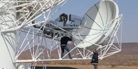 SKA 3: Professor Jonas talking to a technician servicing one of MeerKAT’s radio telescopes. These are among the most complicated and sensitive machines in the world. Image: Chris Marais