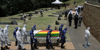 HARARE, ZIMBABWE - JANUARY 27: Pallbearers carry three coffins of the government officials to the grave site at the national shrine on January 27, 2021 in Harare, Zimbabwe. The country's Foreign Minister Sibusiso Moyo is among three government officials being buried today at the Heroes Acre after they died from Covid-19. Transport Minister Joel Biggie Matiza and prisons chief Paradzai Willings Zimondi were also buried here today. (Photo by Tafadzwa Ufumeli/Getty Images)